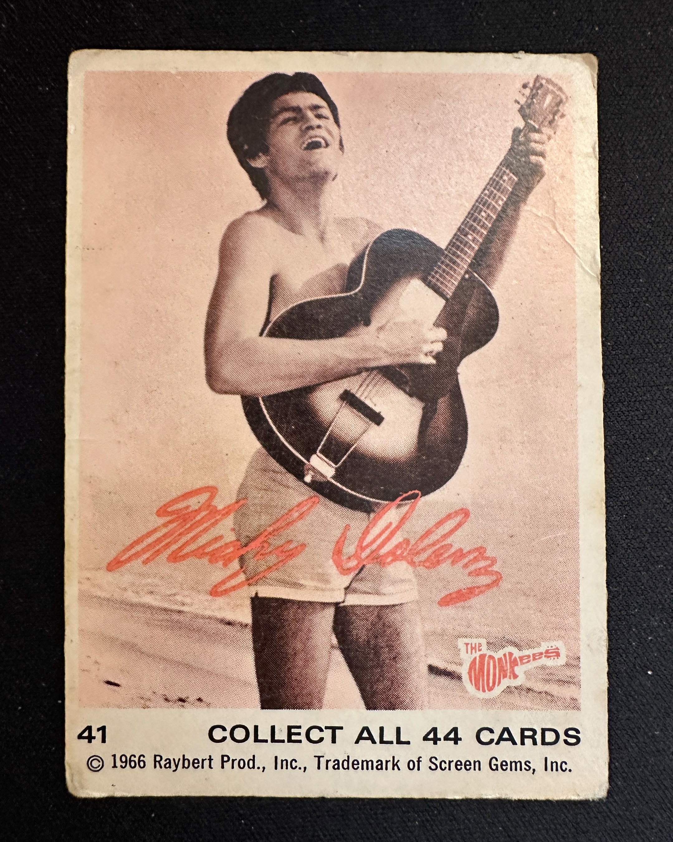 A vintage card of Micky Dolenz playing the guitar