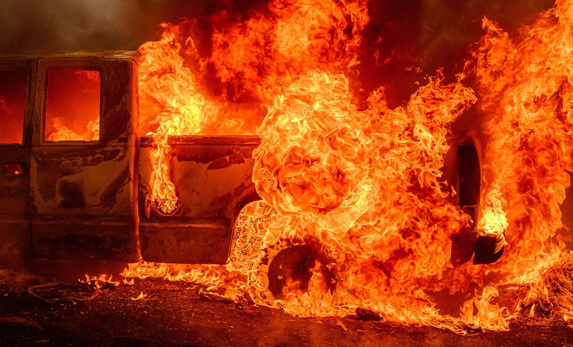 Flames engulf a vehicle during the Thompson Fire in Oroville, California.