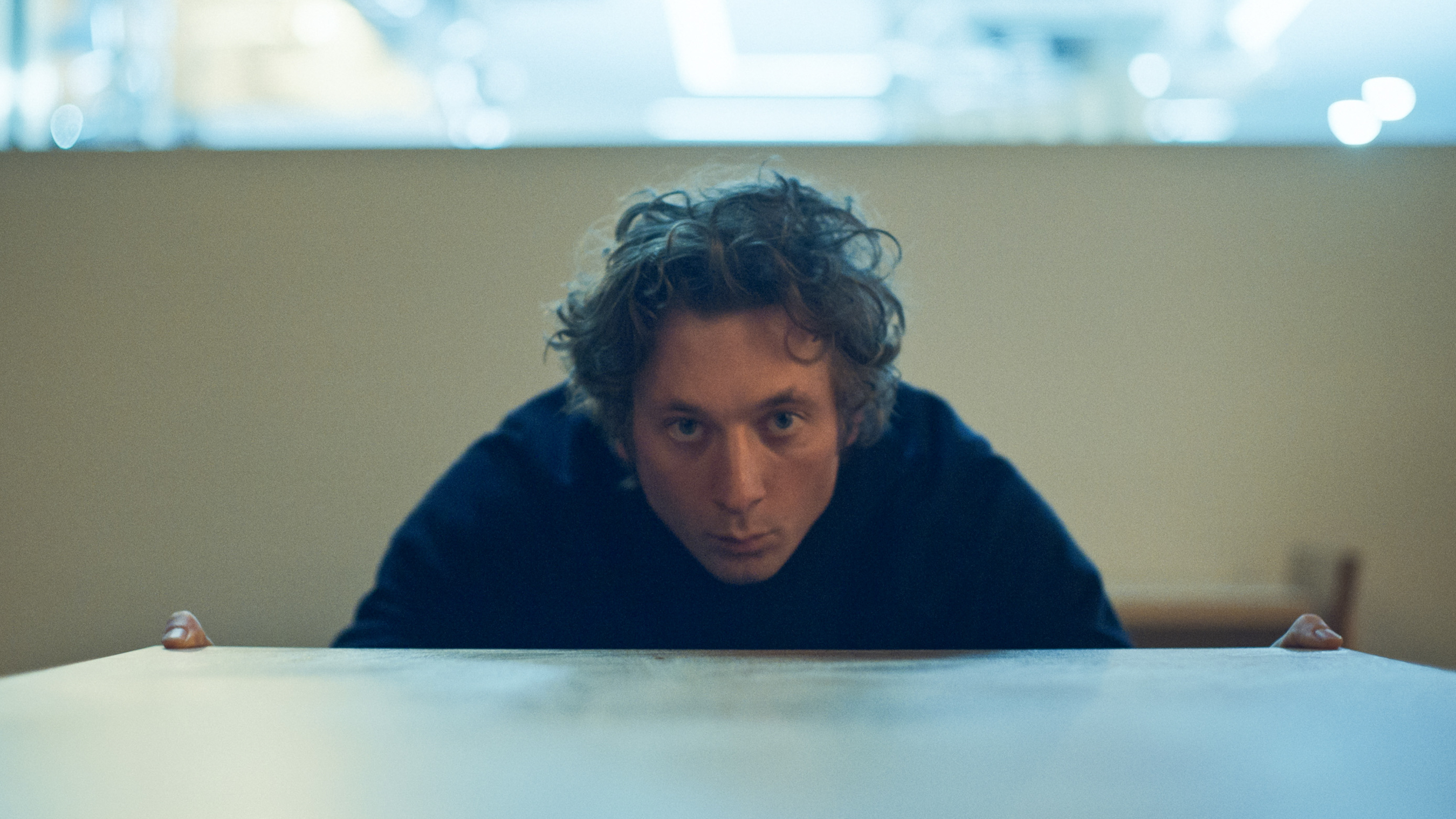 Jeremy Allen White stares at a table at The Bear