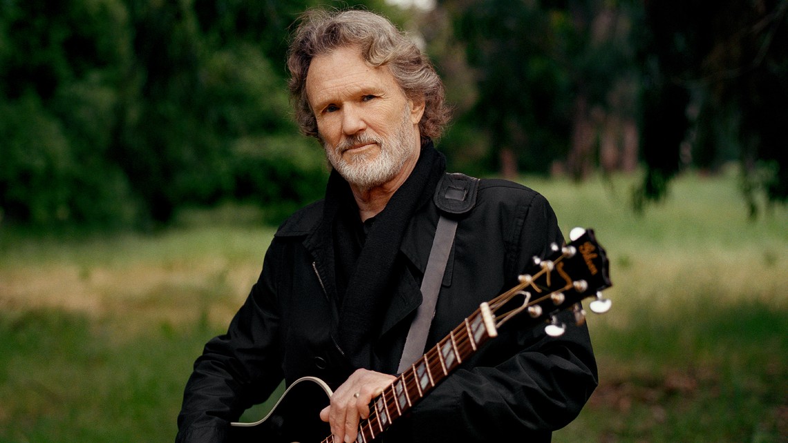 Kris Kristofferson holding a guitar