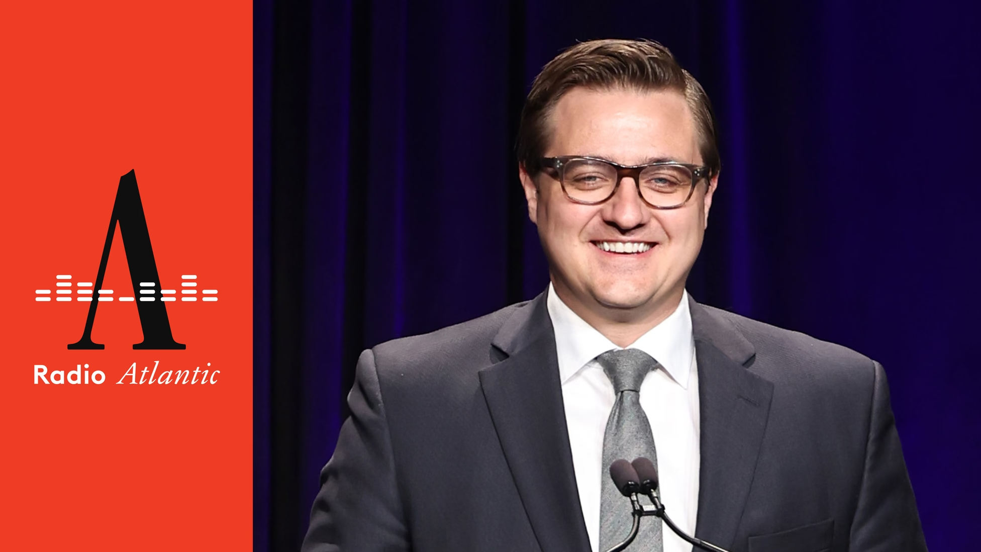 MSNBC host Chris Hayes smiling in a suit