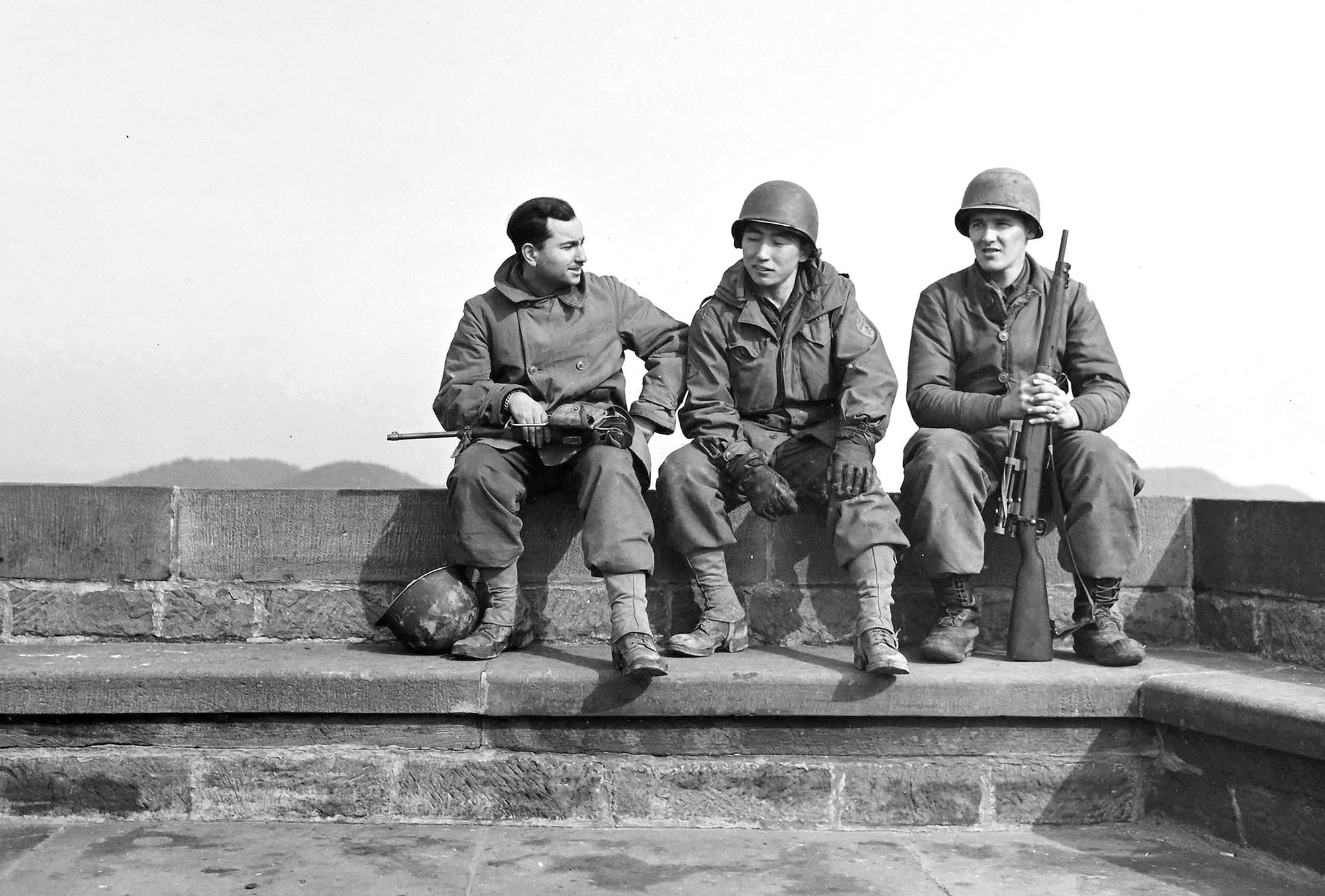 Three U.S. Army soldiers sit together in Dossenheim, France