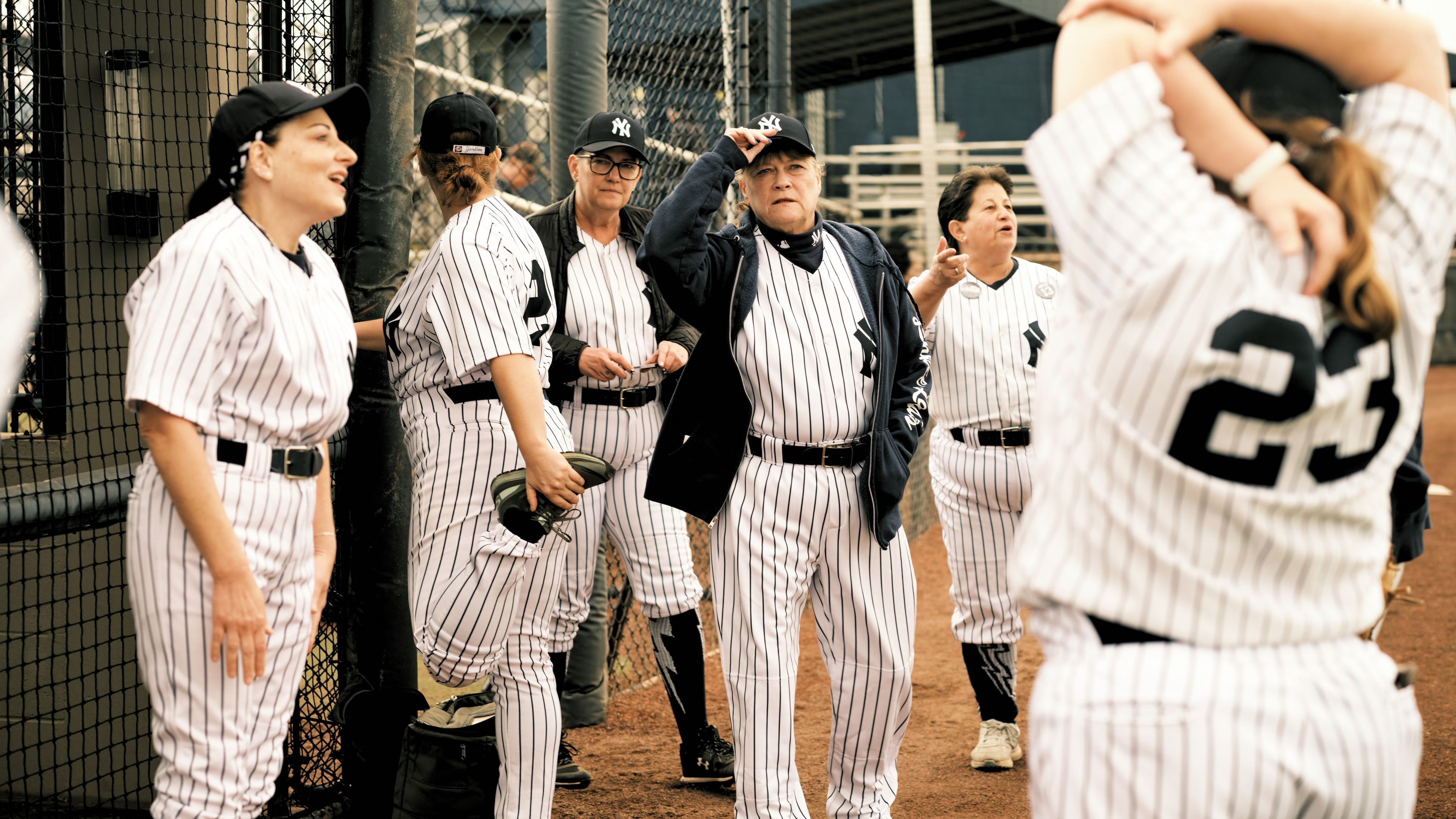 A group of women wearing Yankees uniforms gather during the New York Yankees Women’s Mini-Fantasy Baseball Camp