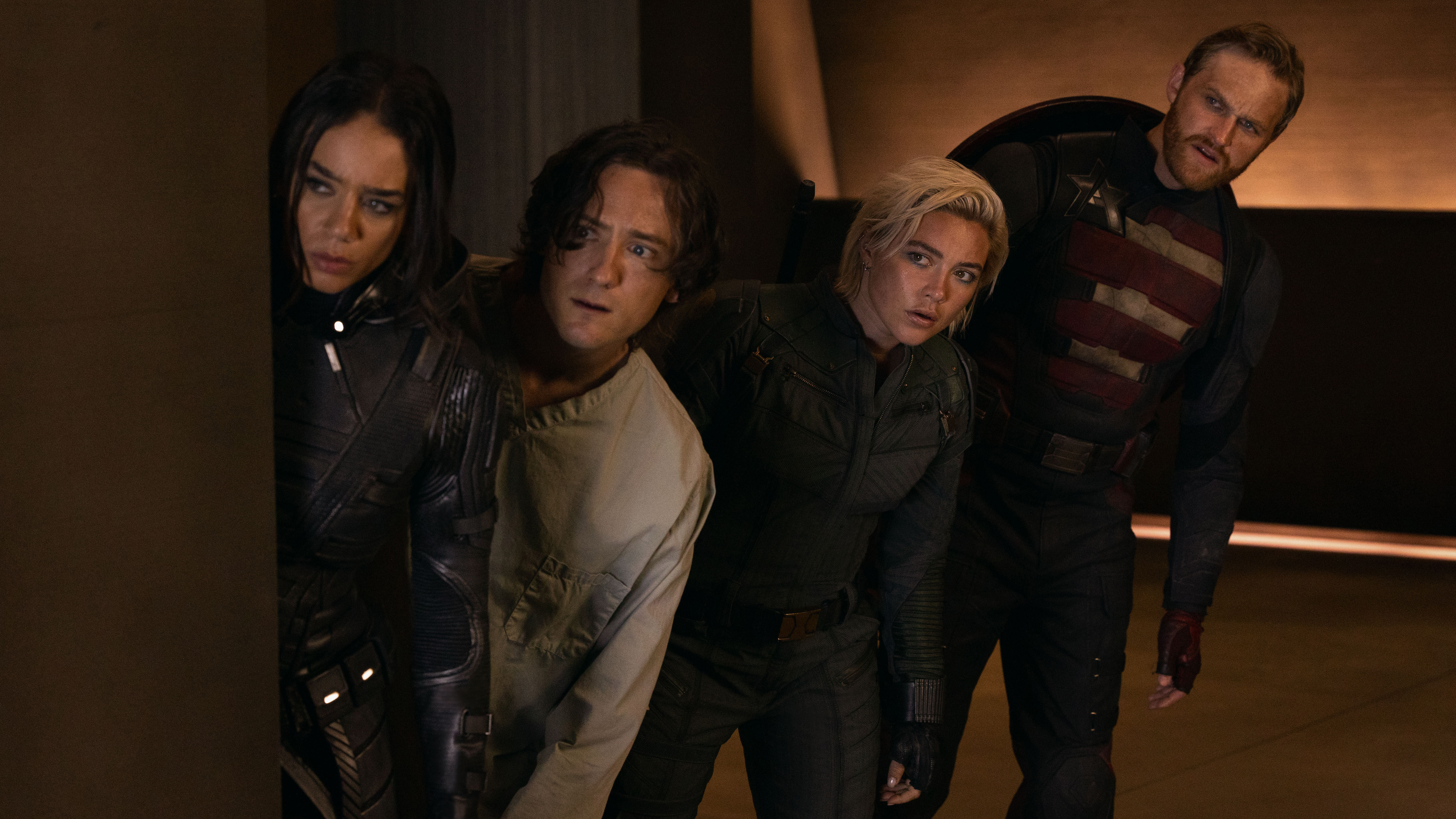 Four anti-heroes look out from behind a wall in Thunderbolts*