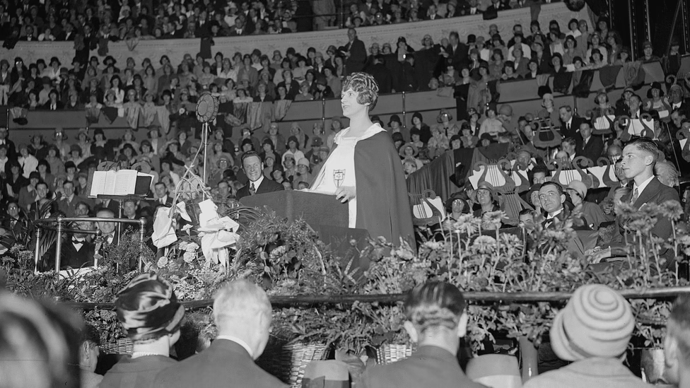 the world-famous evangelist Aimee Semple McPherson speaks in front of a crowd