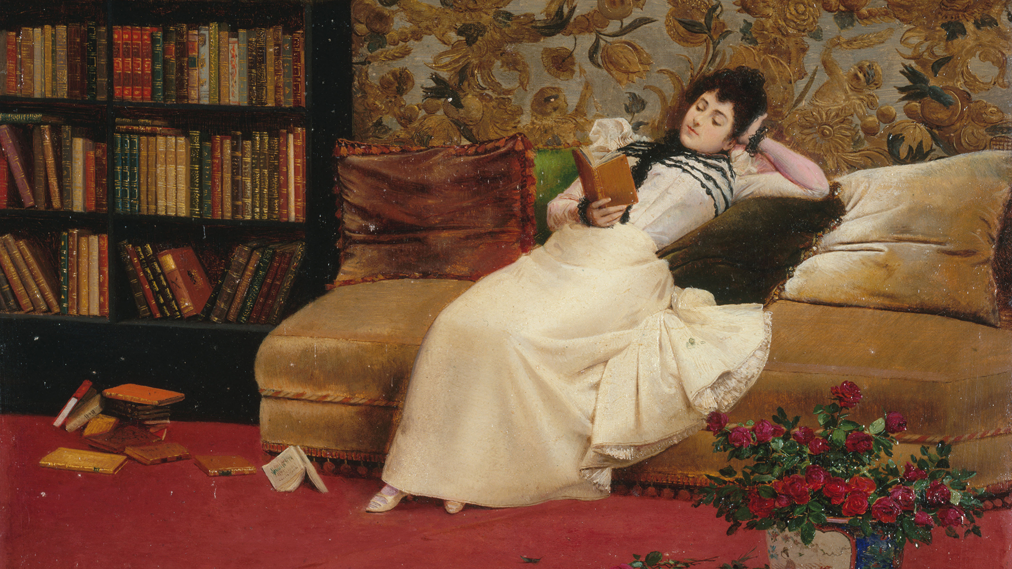 A painting of a woman reclining while she reads a book on a sofa