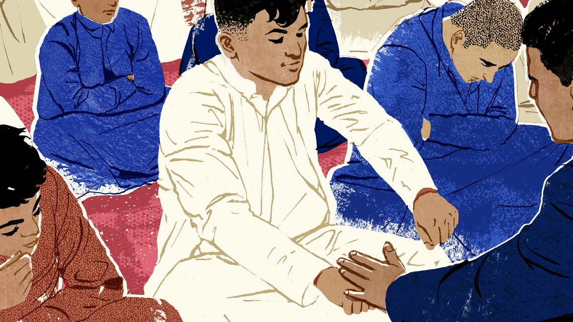 Young boys sit together with closed fists