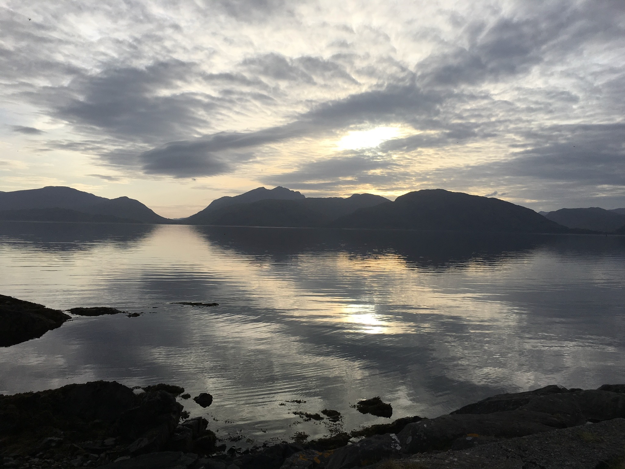 An image of mountains with their reflection in the water