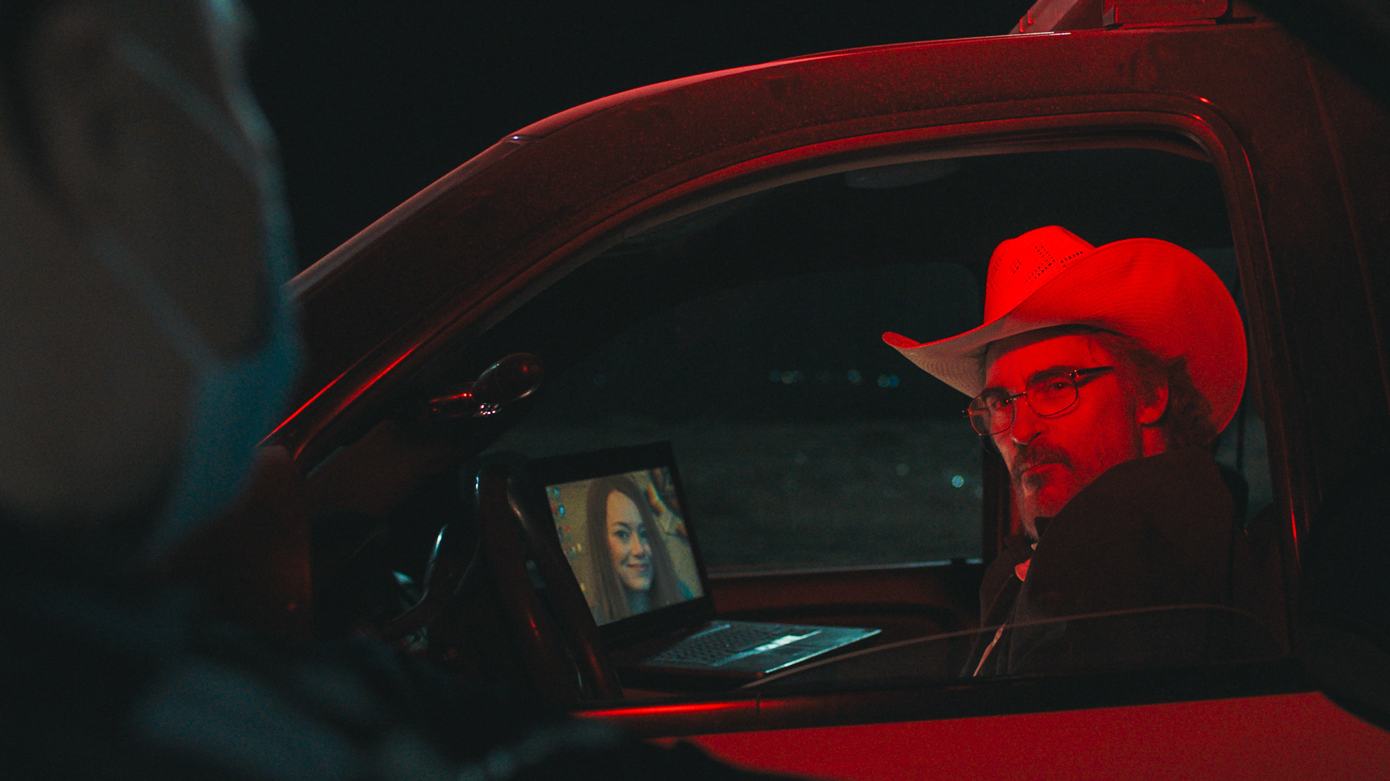 A still from Eddington showing a sheriff in his cop car