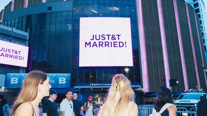 Reading with great signs "JustT&T Marriage!" on the screen at Madison Square Garden, as people walked by