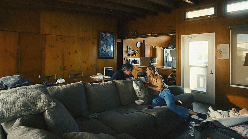 Nathan Fielder and Elizabeth Holmes in wood-paneled room