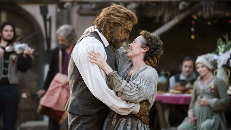 A man made out of wicker embraces a woman
