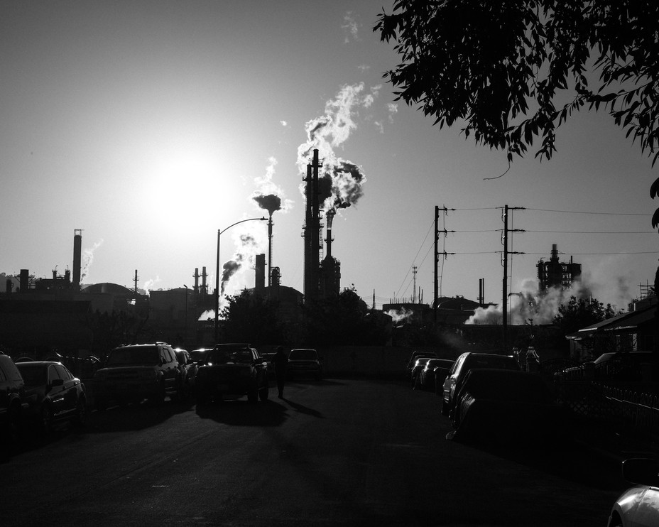 Picture of smokestacks from the Phillips 66 refinery is seen from Figueroa Place, residential street in Wilmington, California
