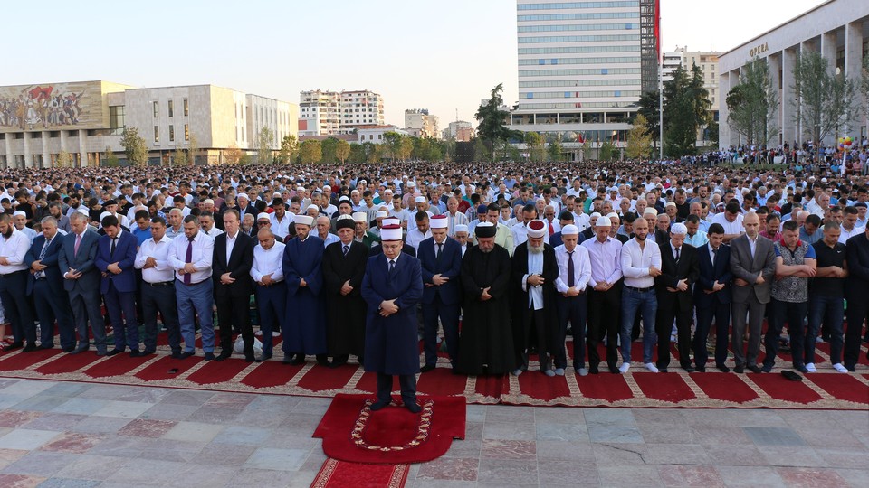 Men gather in Skanderbeg Square in Tirana, Albania, for the Eid al-Fitr prayer service to mark the end of Ramadan in 2017.