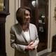 Nancy Pelosi smiling with clasped hands