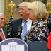 Vice President Mike Pence, President Donald Trump, and Education Secretary Betsy DeVos are seen laughing at a school-choice event in Washington, D.C.