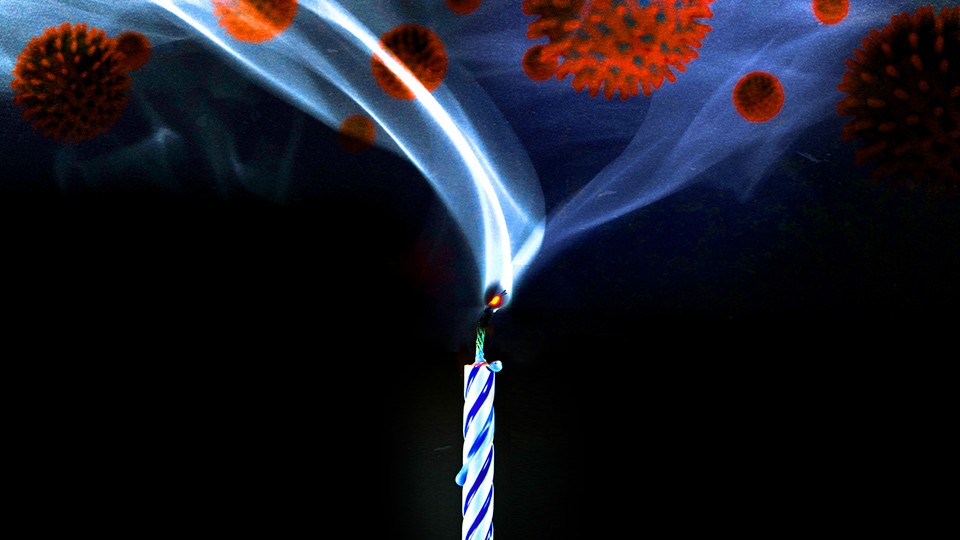 Virus particles appear in a plume of smoke coming out of a birthday candle.