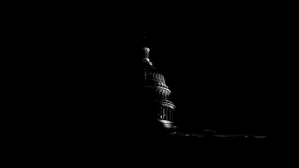 A shadowy photo of the U.S. Capitol at night