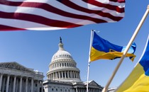 The Capitol building with an American flag and Ukrainian flag framing the shot