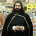Kayvan Novak stands in a grocery-store aisle, in "What We Do in the Shadows."