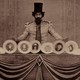 A man wearing a top hat is spinning plates