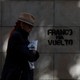 A woman walks past a graffiti which reads "Franco is back" in Barcelona, Spain on October 22, 2017.