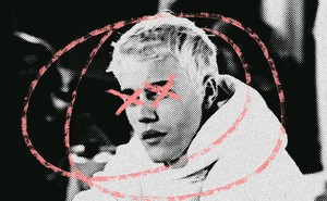 A grainy photo of Justin Bieber with his head circled and his eyes x-ed out