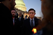 A photo of House Speaker Mike Johnson attending a candlelight vigil outside the U.S. Capitol.