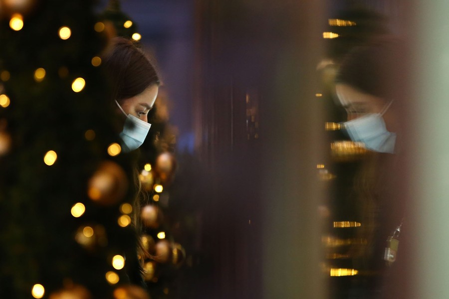 A person is seen wearing a face mask while shopping.
