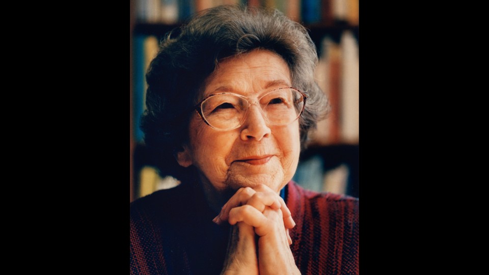 A photo of Beverly Cleary smiling, resting her chin on her clasped hands