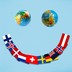 An illustration of a smiley face, with two globes as the eyes and a spread of countries' flags as the mouth