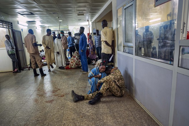 woman cries in the hospital with a wounded soldier
