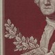 An embroidered portrait of George Washington next to the faded blue silk flag that indicated his presence on the Revolutionary War battlefield.