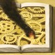 illustration of a book lying open, full of gears and cogs, with a fire starting and smoke