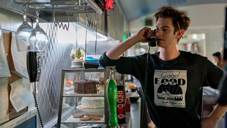 Andrew Garfield on the phone in a restaurant kitchen in "Tick, Tick . . . Boom"