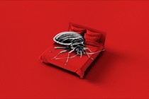 A black-and-white graphic of a giant bedbug on top of a red bedspread, against a red backdrop