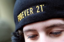 A person wearing a black Forever 21 hat