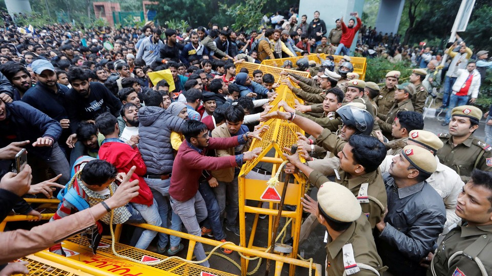 Police and protesters scuffle outside a university in New Delhi.