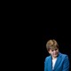 Nicola Sturgeon in a blue blazer on black background