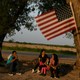 Central American asylum seekers wait to be transported to a processing facility after turning themselves in to the U.S. Border Patrol in Los Ebanos, Texas.