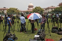 Journalists stand outside India's Supreme Court in New Delhi.