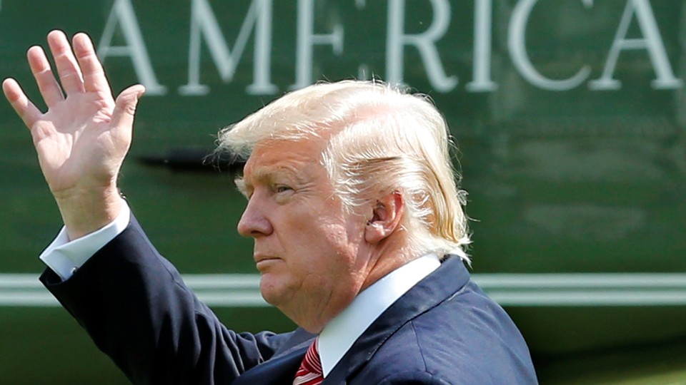 President Trump waves from the White House lawn as he departs for Camp David on Friday.