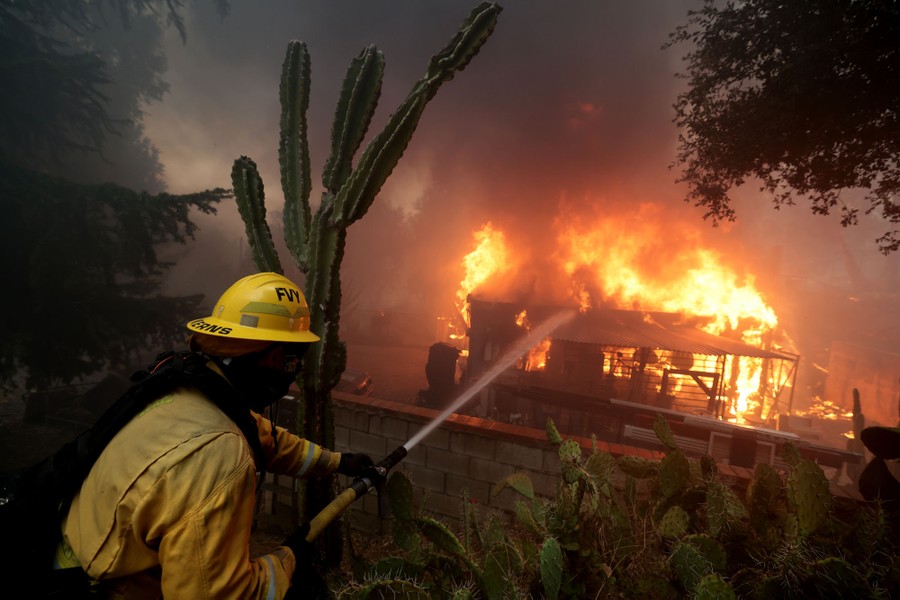 Firefighters battle a house fire.