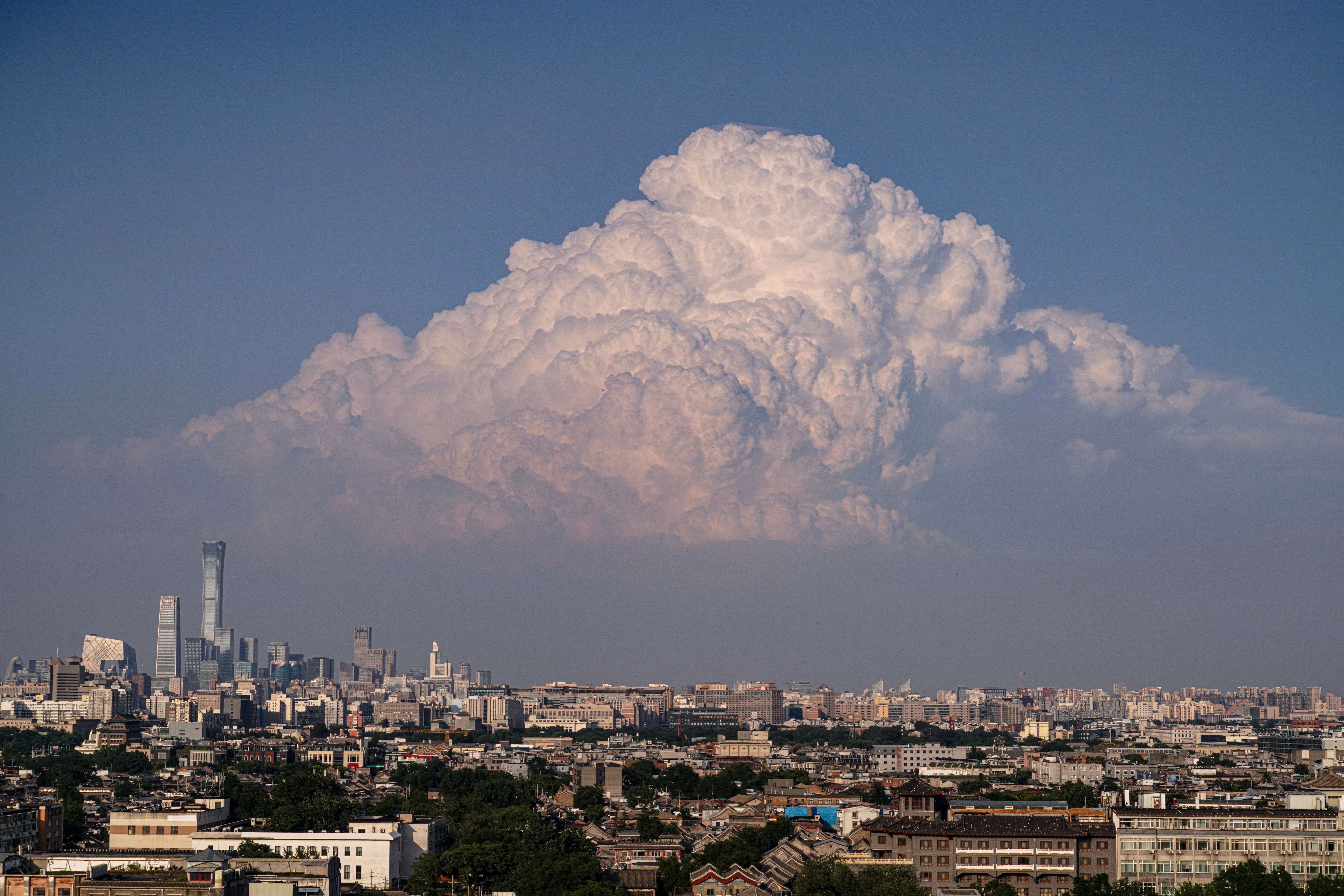 A bank of clouds rises above the skyline of Beijing.