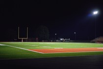 An empty football field at night.