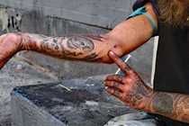A drug user prepares to inject himself