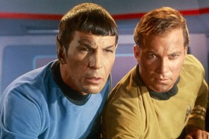Spock and Captain James T. Kirk lean in to look intently at a screen