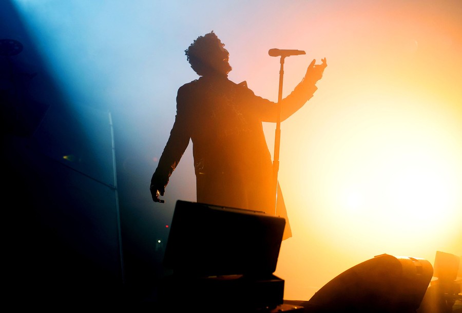 A silhouette of a performer onstage