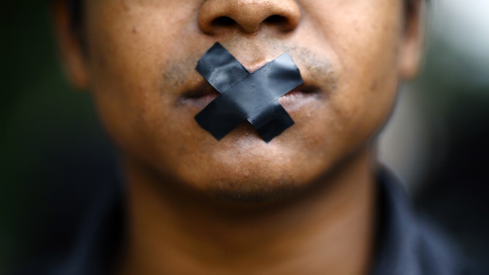 A man with tape over his mouth.