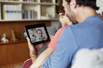 A father and son chat use Skype to video chat